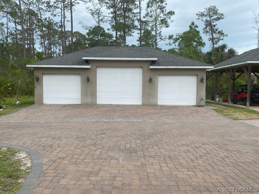 32 Winchester Road Ormond Beach, FL 32174 - Photo 10 of 84 a front view of a house with a yard and garage