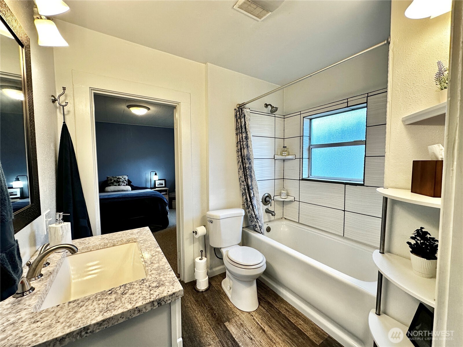303 South Buckner Street Centralia, WA 98531 - Photo 25 of 33 a bathroom with a granite countertop sink mirror vanity bathtub and toilet