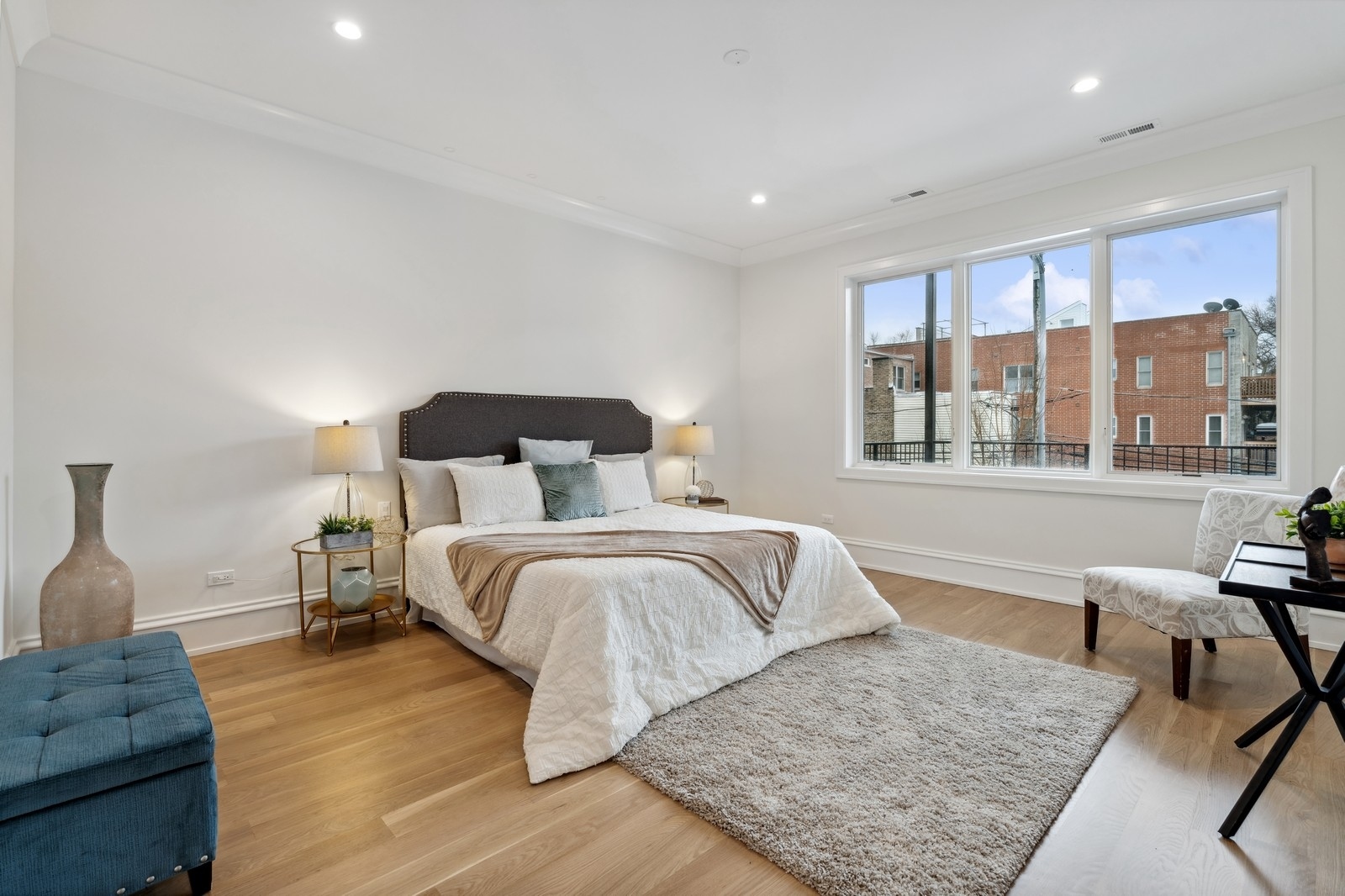 1511 West Byron Street, Unit 2 Chicago, IL 60613 - Photo 11 of 21 a bedroom with a large bed and wooden floor