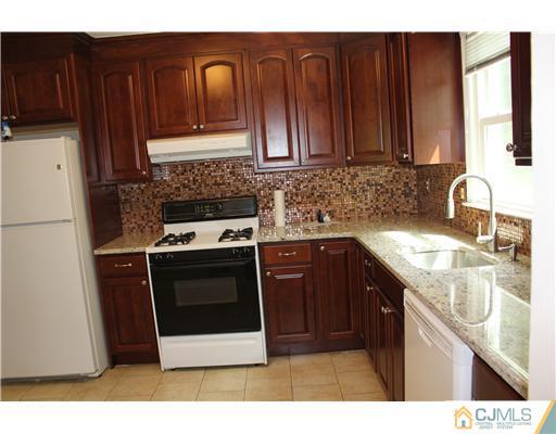 10 Butler Road Edison, NJ 08820 - Photo 7 of 13 a kitchen with stainless steel appliances granite countertop a sink stove and refrigerator