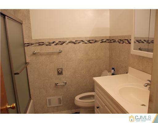 10 Butler Road Edison, NJ 08820 - Photo 9 of 13 a bathroom with a sink and a mirror