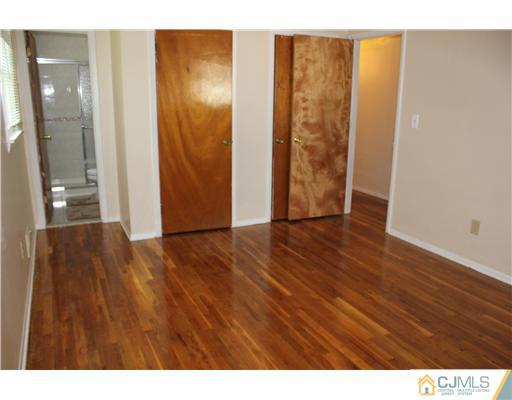 10 Butler Road Edison, NJ 08820 - Photo 10 of 13 a view of an empty room with wooden floor