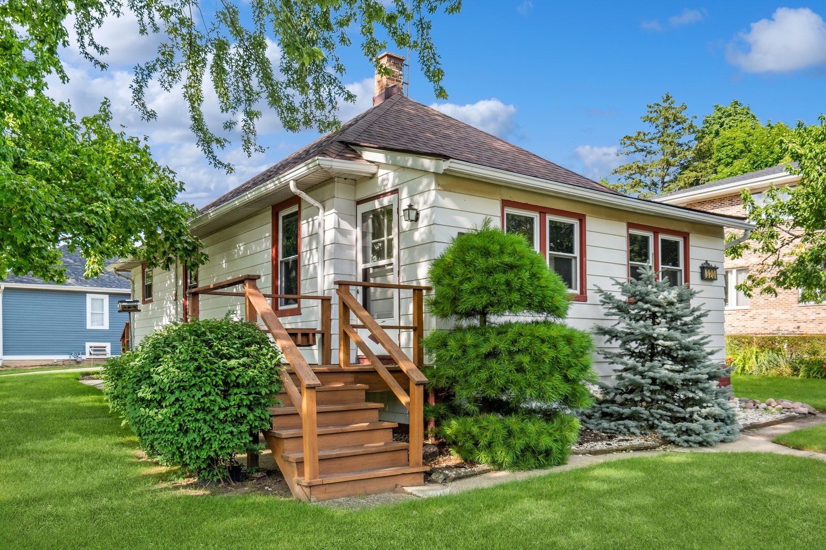 a front view of a house with a garden