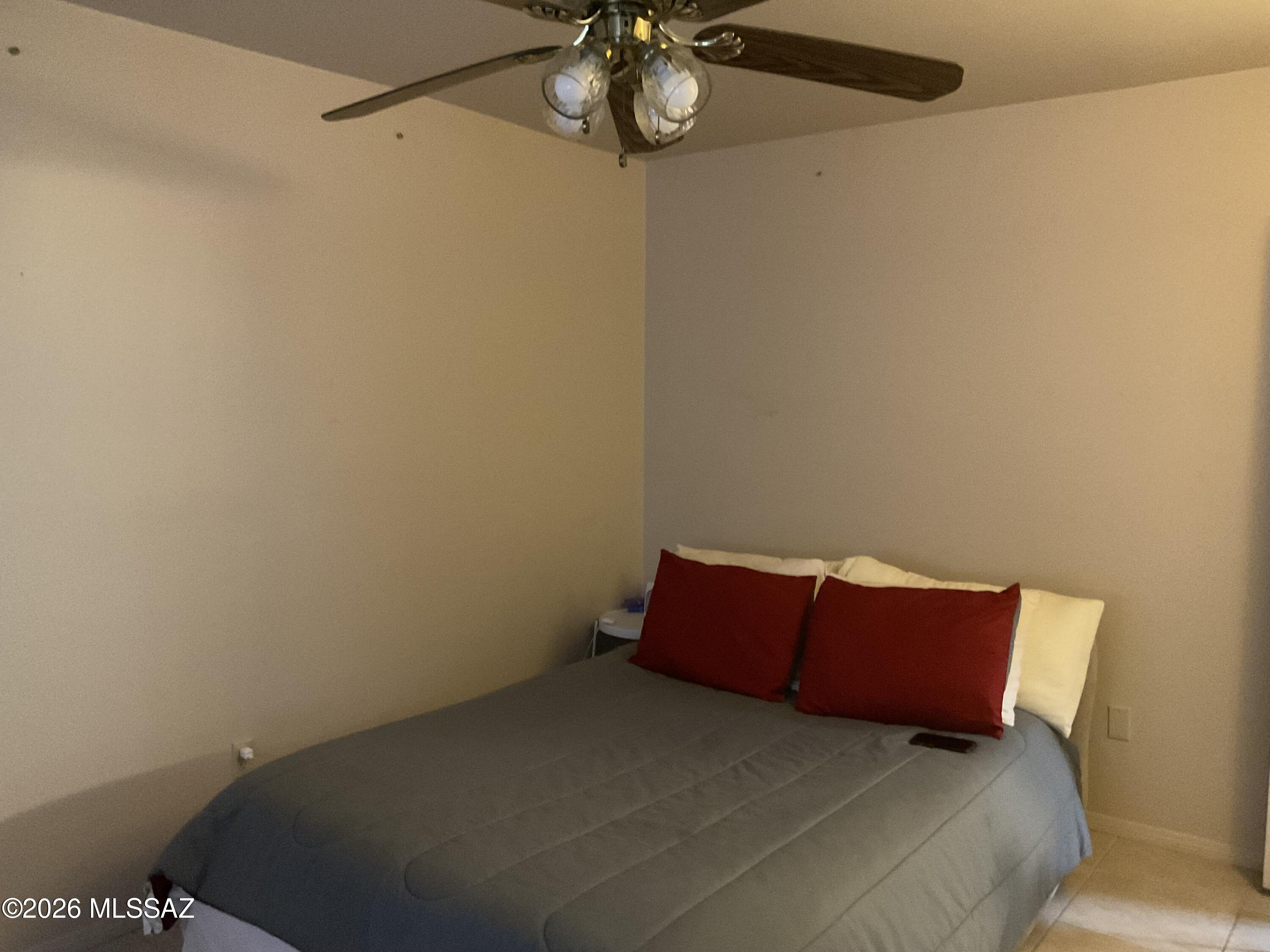 4060 North Swan Road Tucson, AZ 85718 - Photo 28 of 47 a bed sitting in a bedroom next to a bathroom