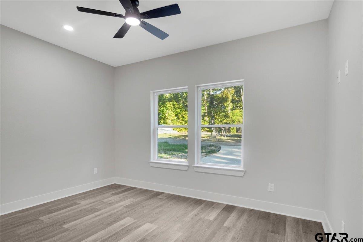 147 Arvel Street Bullard, TX 75757 - Photo 13 of 23 a view of a big room with wooden floor and windows