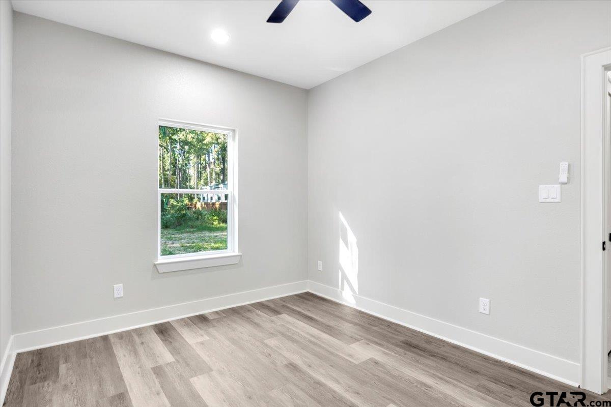 147 Arvel Street Bullard, TX 75757 - Photo 18 of 23 an empty room with a window and a ceiling fan