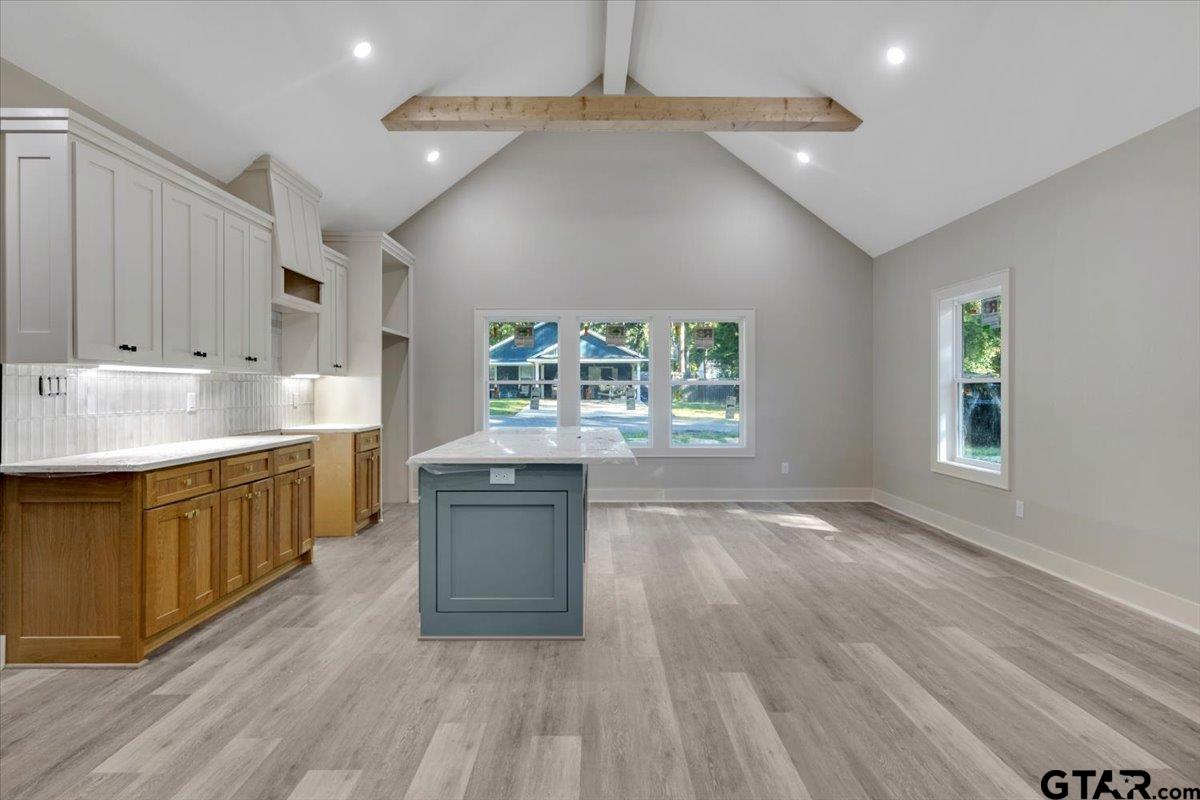 147 Arvel Street Bullard, TX 75757 - Photo 7 of 23 a open kitchen with kitchen island a sink dishwasher a stove and a refrigerator with wooden floor