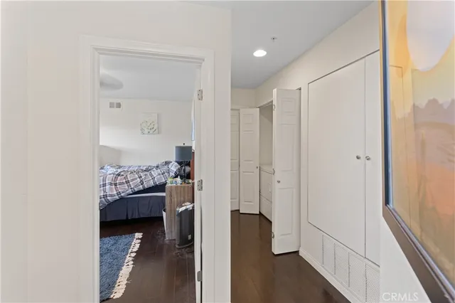 a bathroom with a granite countertop bathtub sink vanity mirror and toilet