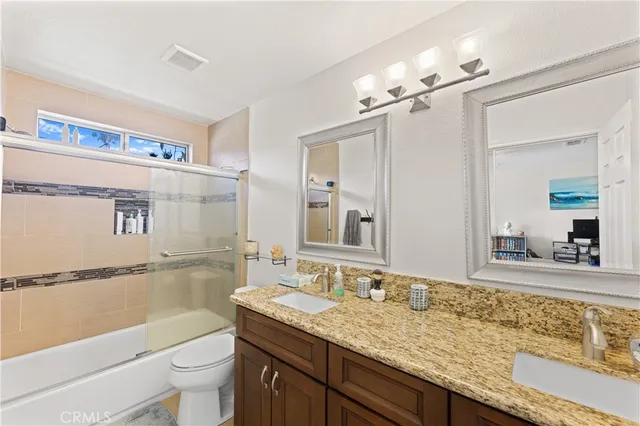 a kitchen with stainless steel appliances granite countertop a refrigerator a stove a sink dishwasher a dining table and chairs with wooden floor