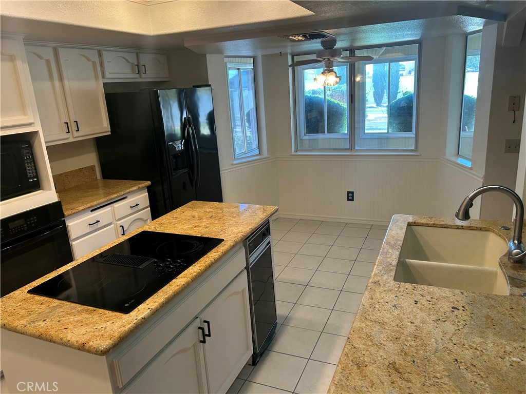 20187 Itasca Road Apple Valley, CA 92308 - Photo 22 of 35 a kitchen with stainless steel appliances granite countertop a sink stove and refrigerator