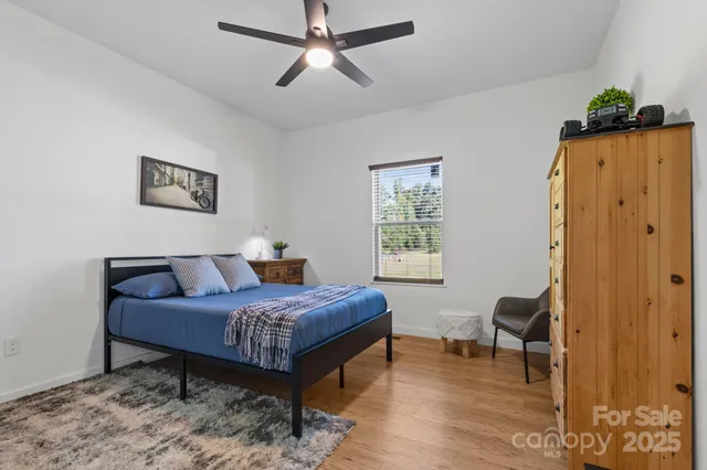a bedroom with furniture and a window