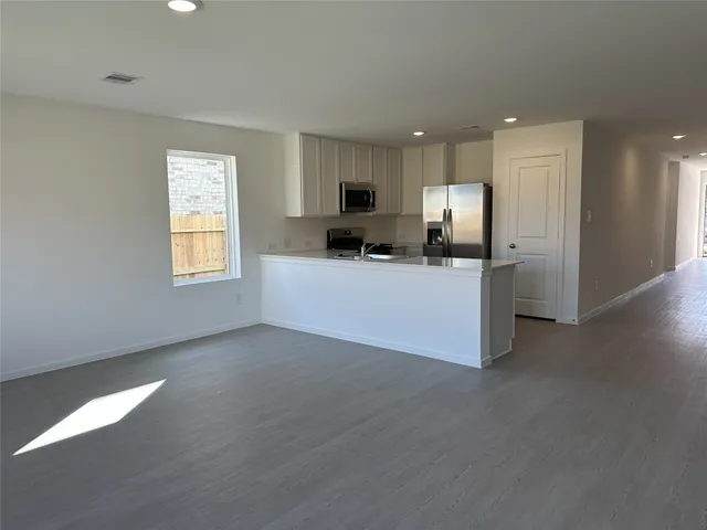 a view of a kitchen with furniture and a window