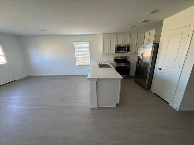 a kitchen with refrigerator and window