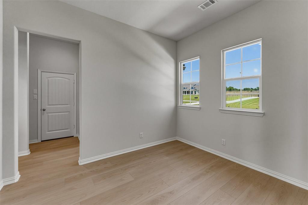 114 Hillview Trail Decatur, TX 76234 - Photo 10 of 27 Neutral gray walls complement wood-finish flooring