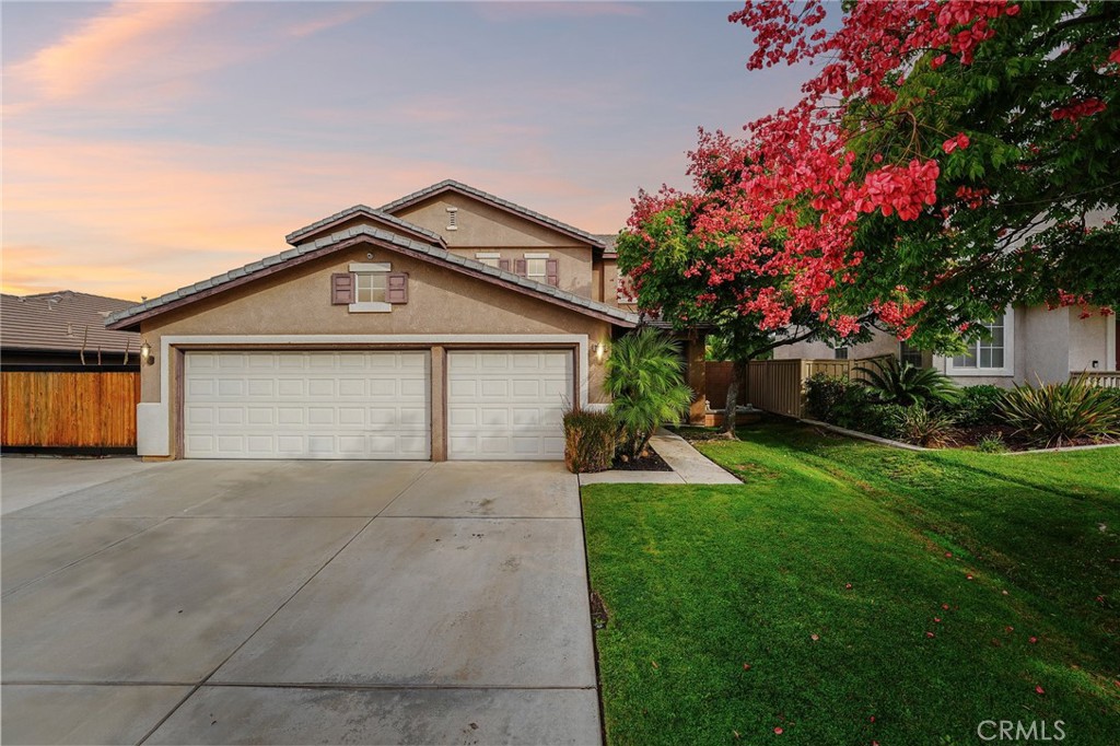 19550 Rotterdam Street Riverside, CA 92508 - Photo 1 of 1 a front view of a house with a yard and garage