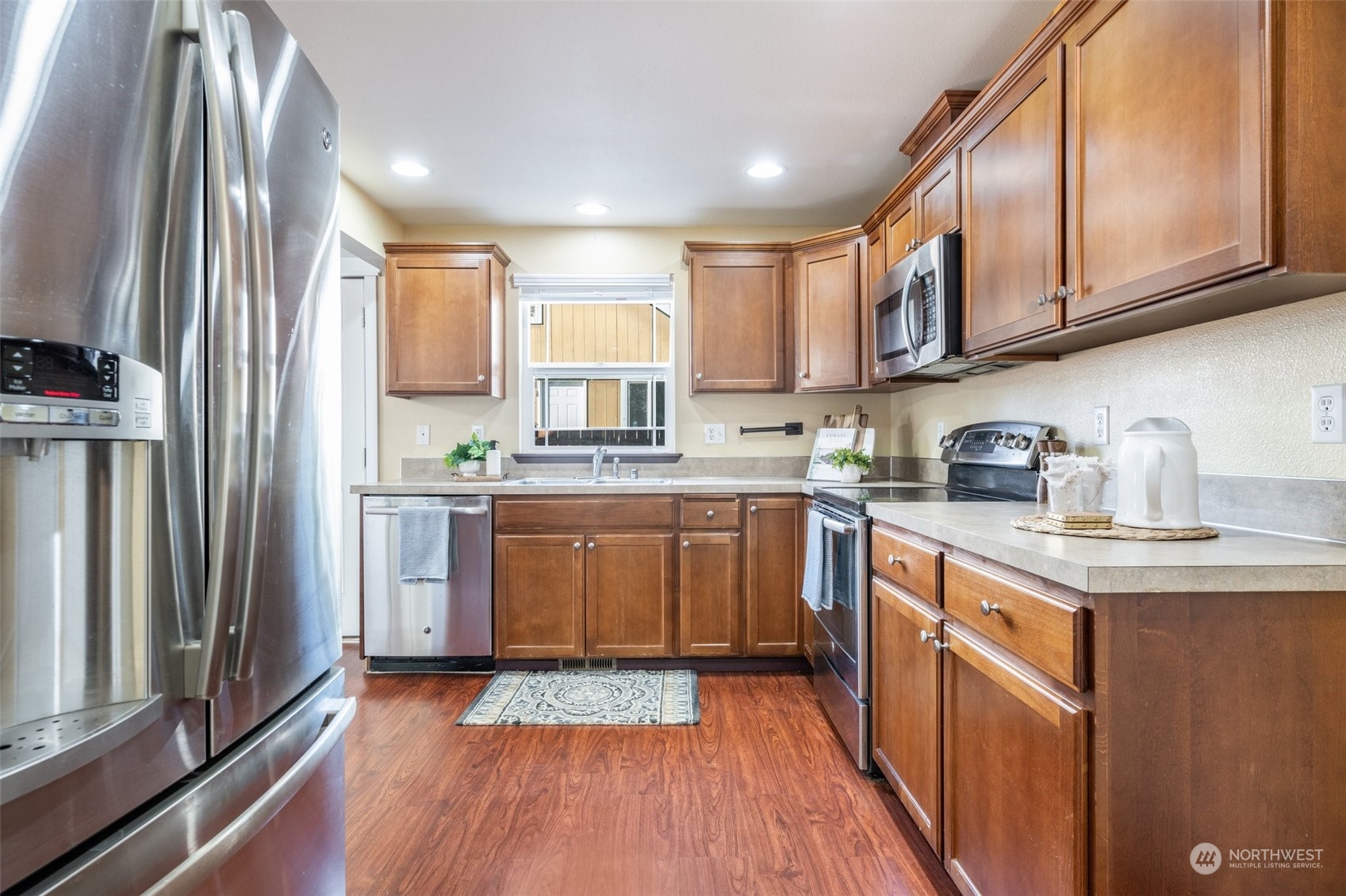 20122 Shamon Court Southwest Centralia, WA 98531 - Photo 13 of 40 a kitchen with stainless steel appliances granite countertop a refrigerator a sink dishwasher a stove and white countertops with wooden floor
