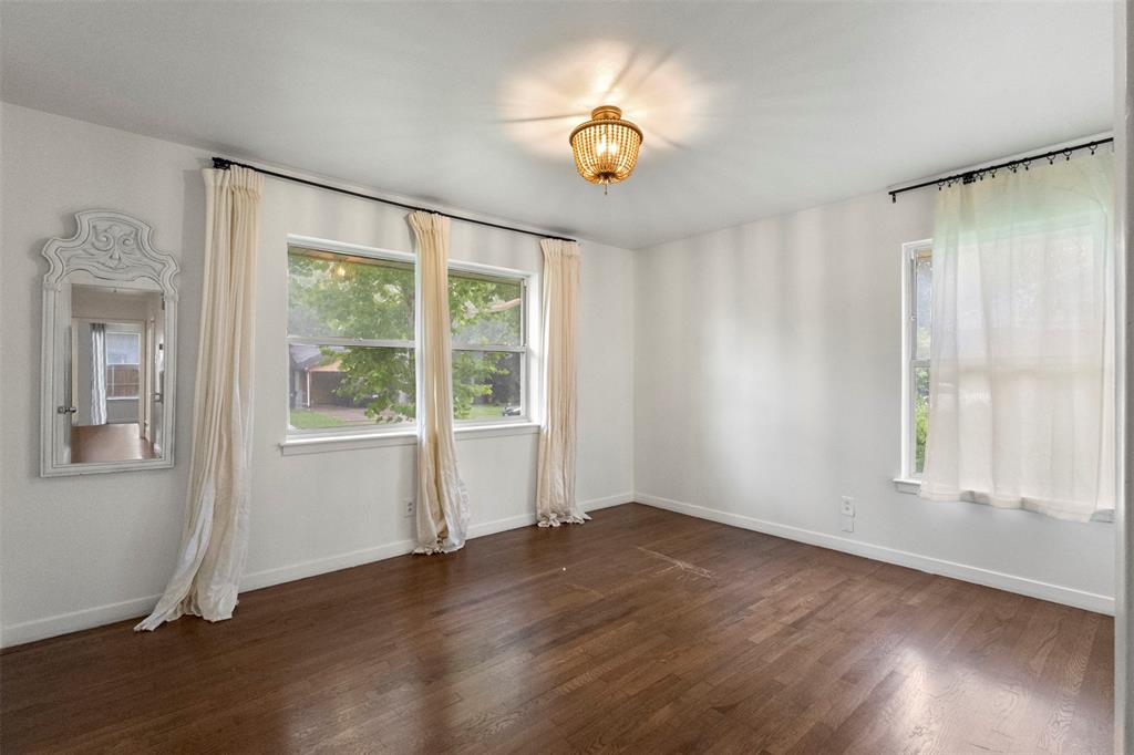 3304 Crest Ridge Drive Dallas, TX 75228 - Photo 11 of 16 a view of an empty room with wooden floor and a window