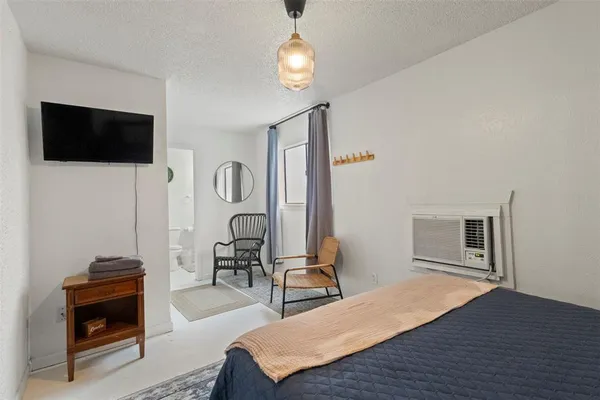 a bedroom with a bed and a chandelier