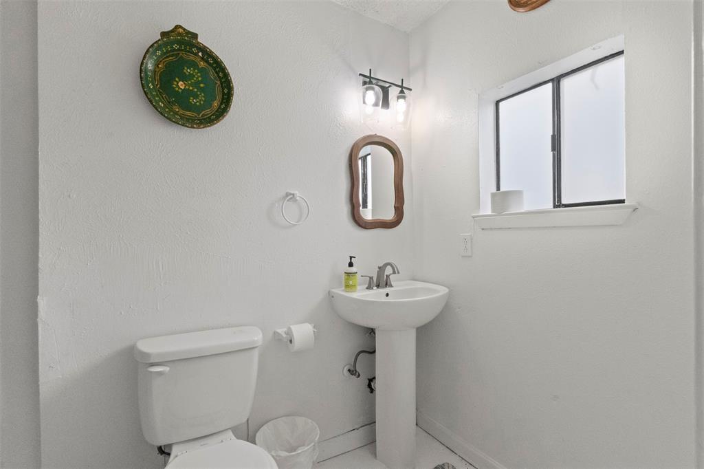 3304 Crest Ridge Drive Dallas, TX 75228 - Photo 15 of 16 a bathroom with a toilet sink and mirror