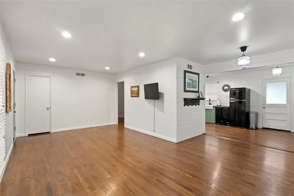 a view of a kitchen with a sink and a refrigerator