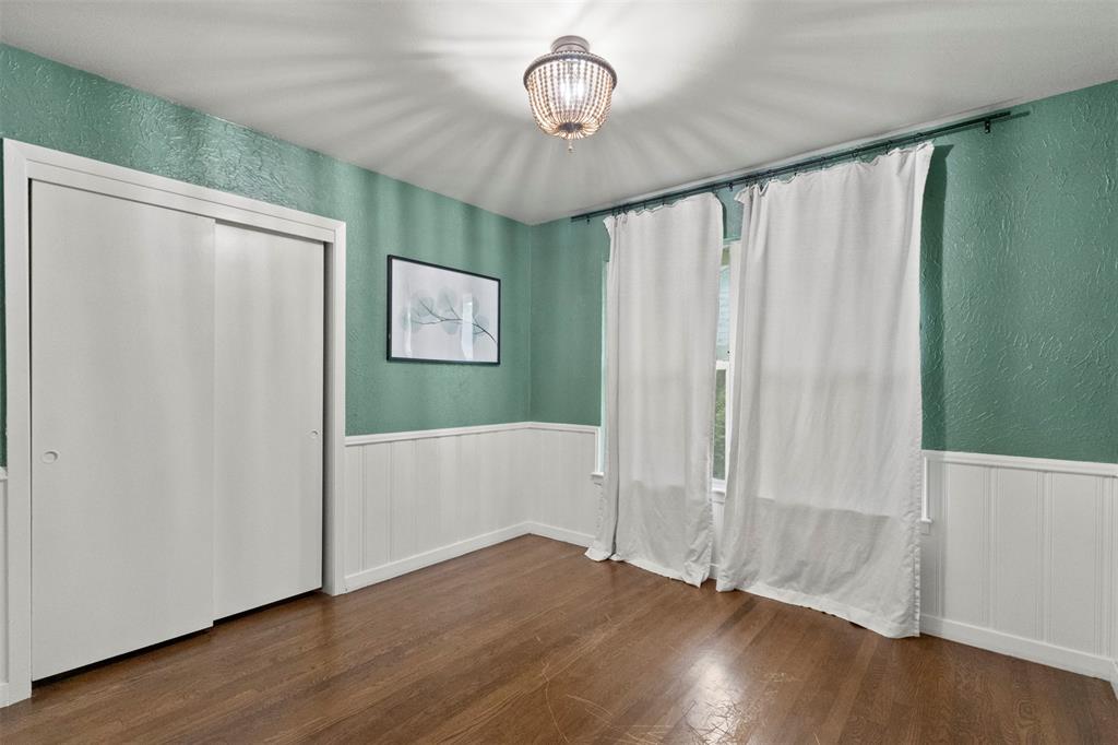 3304 Crest Ridge Drive Dallas, TX 75228 - Photo 10 of 16 a view of an empty room with wooden floor and a window