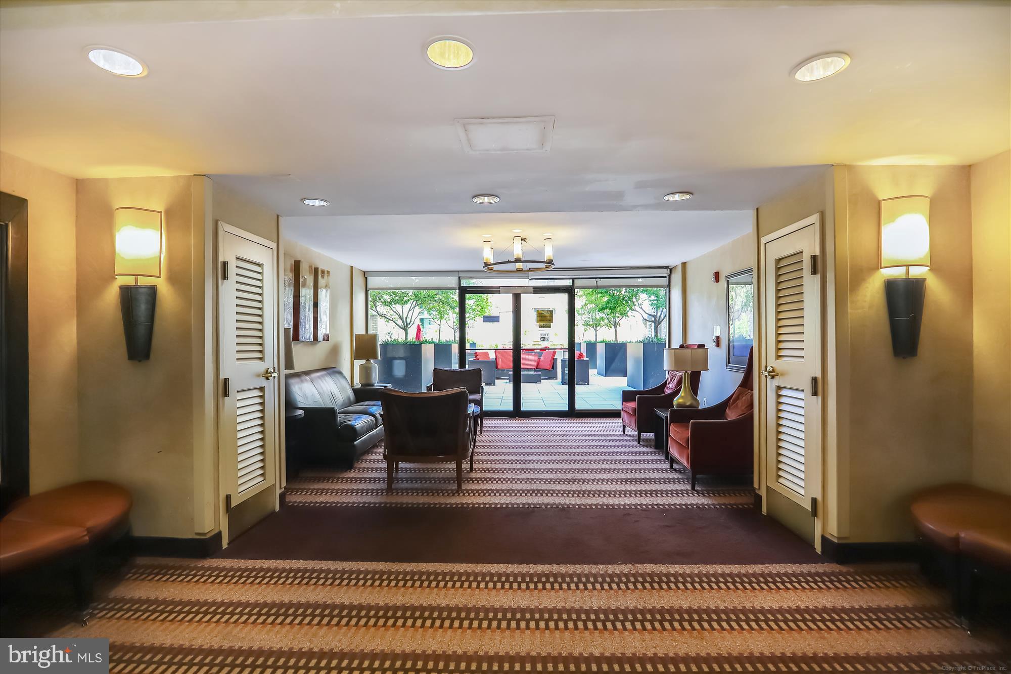 950 25th Street Northwest, Unit 709N Washington, DC 20037 - Photo 31 of 49 a living room with furniture a rug and a chandelier