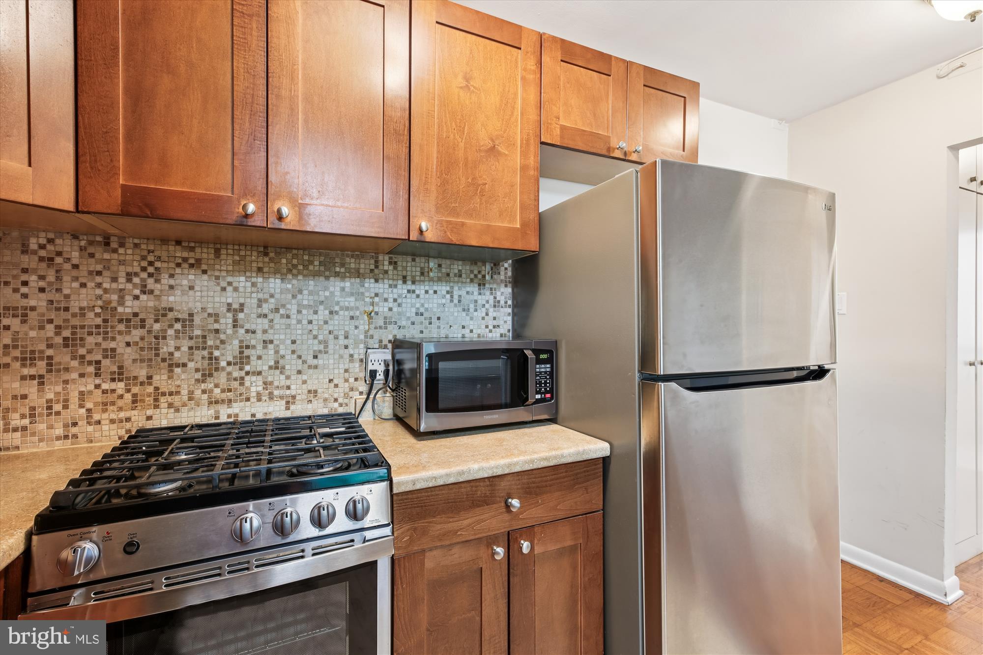 950 25th Street Northwest, Unit 709N Washington, DC 20037 - Photo 8 of 49 a kitchen with stainless steel appliances a refrigerator stove and microwave