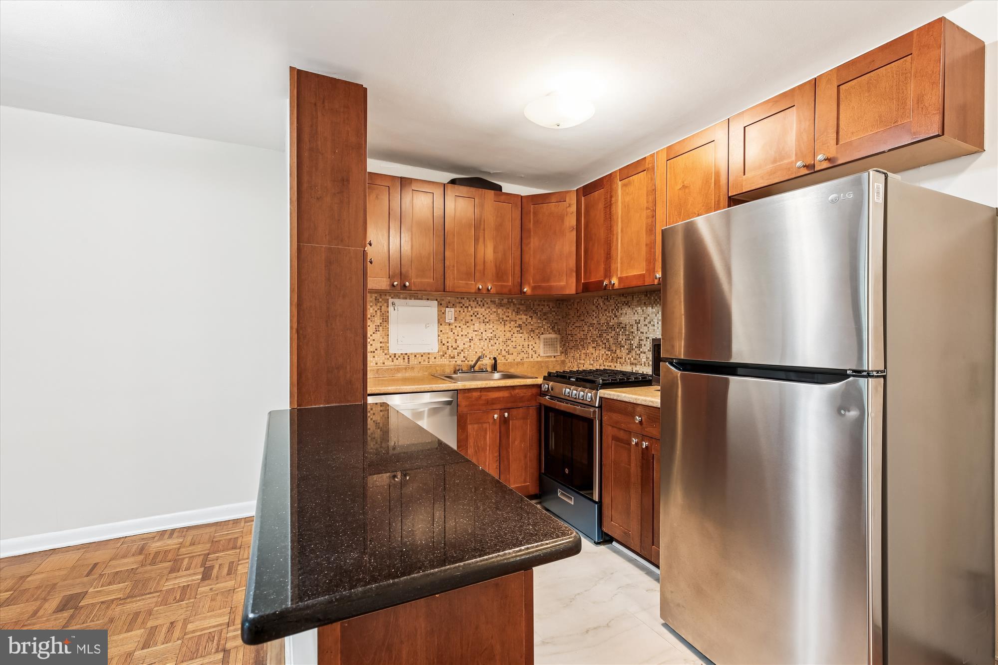 950 25th Street Northwest, Unit 709N Washington, DC 20037 - Photo 9 of 52 a kitchen with stainless steel appliances granite countertop a refrigerator a sink and a stove
