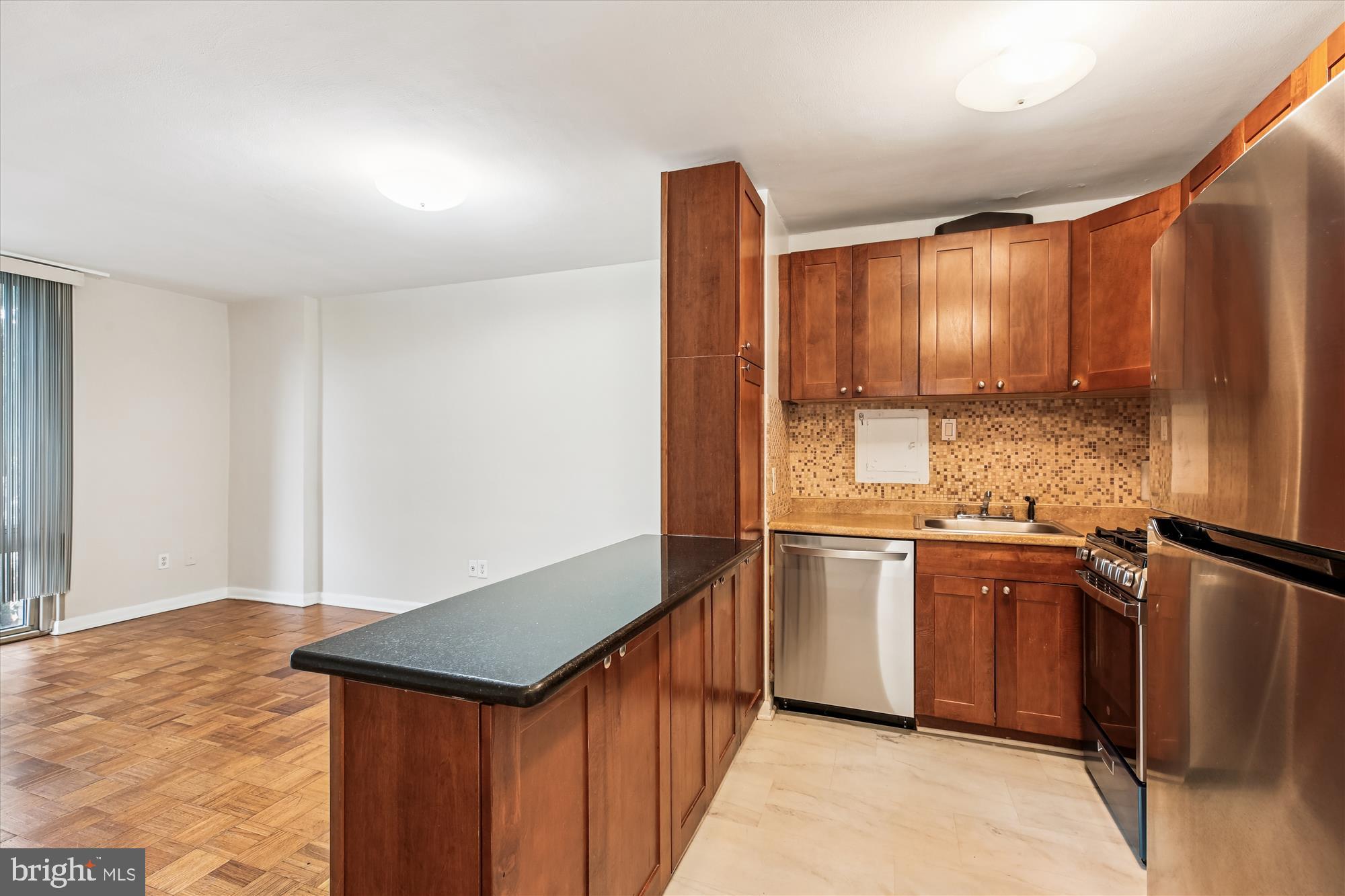 950 25th Street Northwest, Unit 709N Washington, DC 20037 - Photo 10 of 52 a kitchen with stainless steel appliances granite countertop a stove a sink and a refrigerator