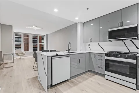 a kitchen with a sink cabinets and stainless steel appliances