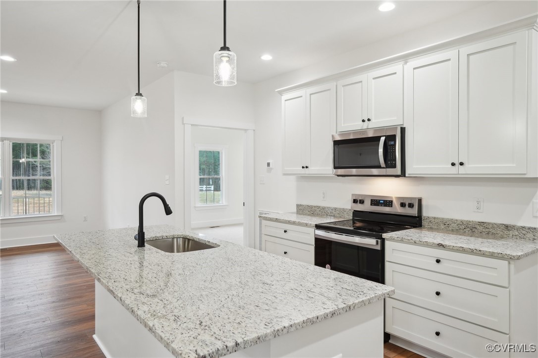 2359 Cedar Hill Road Mineral, VA 23117 - Photo 15 of 36 a kitchen with granite countertop a stove a sink a refrigerator and cabinets