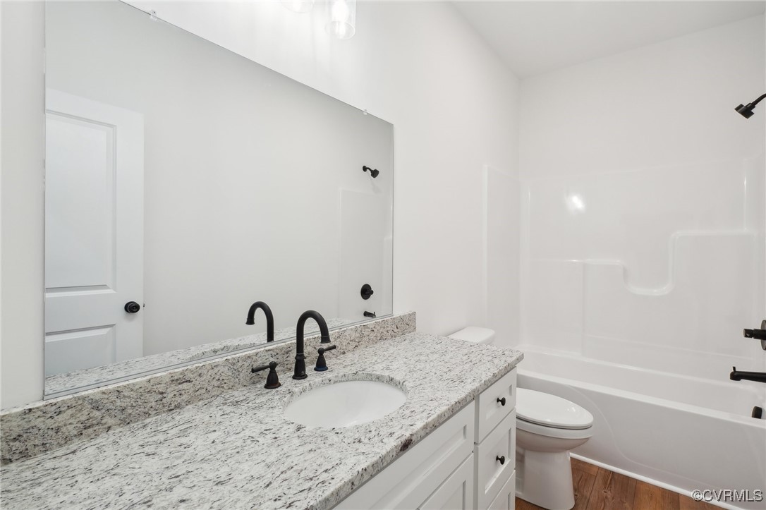 2359 Cedar Hill Road Mineral, VA 23117 - Photo 31 of 36 a bathroom with a granite countertop sink a toilet and a bathtub