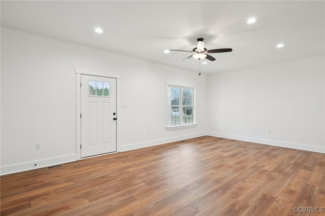 2359 Cedar Hill Road Mineral, VA 23117 - Photo 9 of 36 an empty room with wooden floor ceiling fan & windows