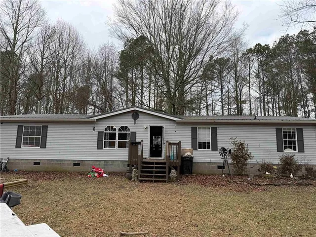 a view of a house with a yard and sitting area