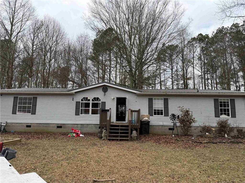 828 Harrison Road Carrollton, GA 30117 - Photo 1 of 20 a view of a house with a yard and sitting area