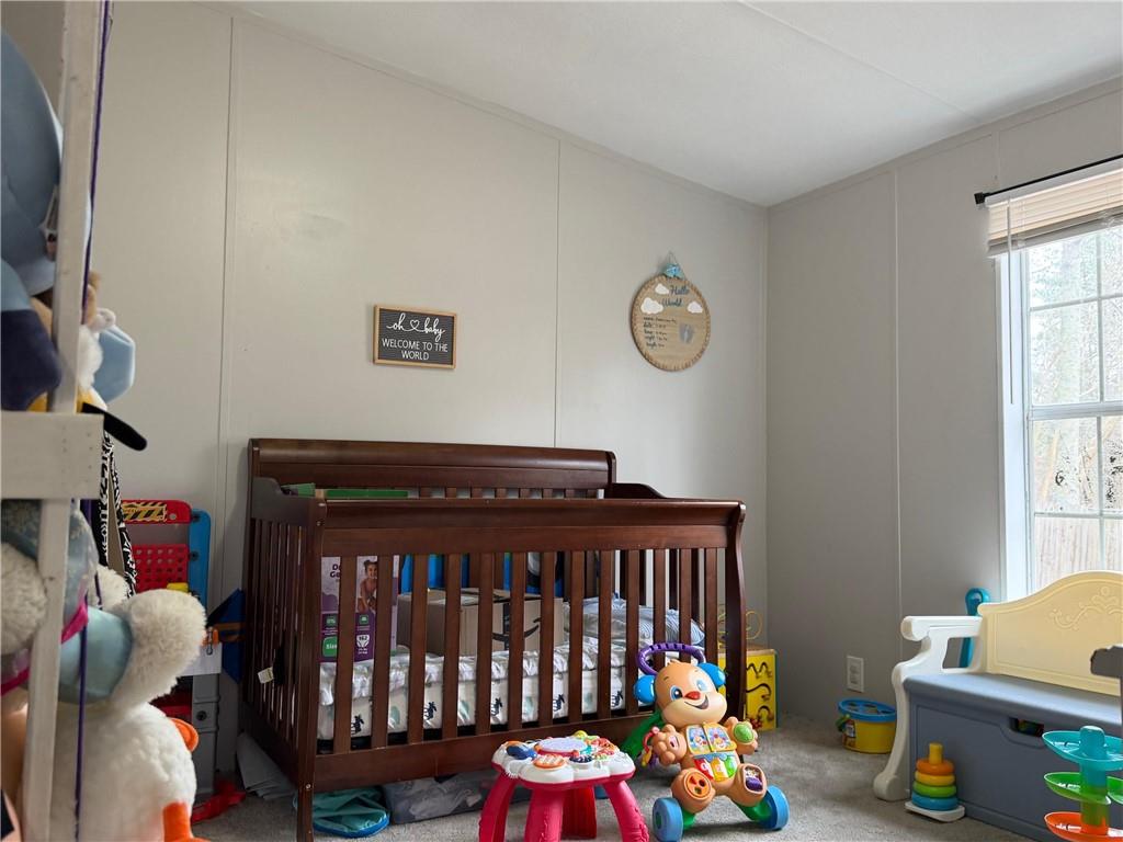 828 Harrison Road Carrollton, GA 30117 - Photo 13 of 20 a bedroom with baby crib and a window