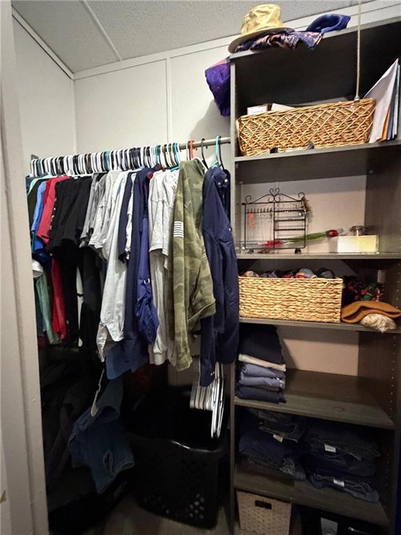 828 Harrison Road Carrollton, GA 30117 - Photo 17 of 20 a view of walk in closet with clothes and shoes