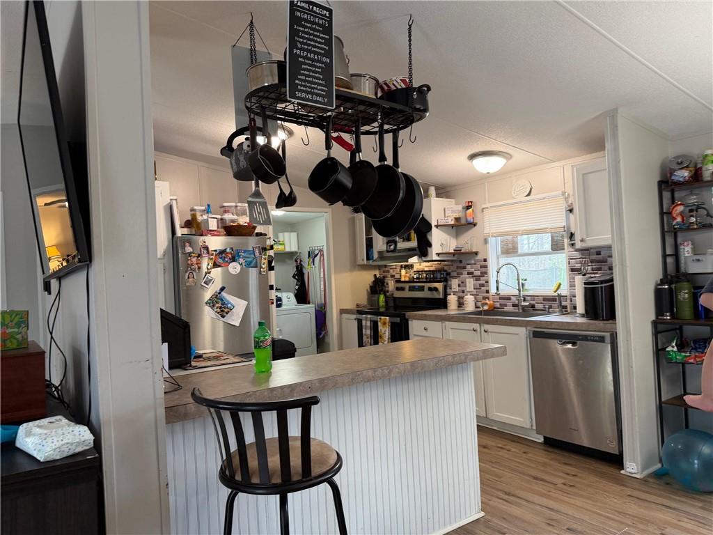 828 Harrison Road Carrollton, GA 30117 - Photo 18 of 20 a kitchen with stainless steel appliances granite countertop a dining table chairs and granite counter tops