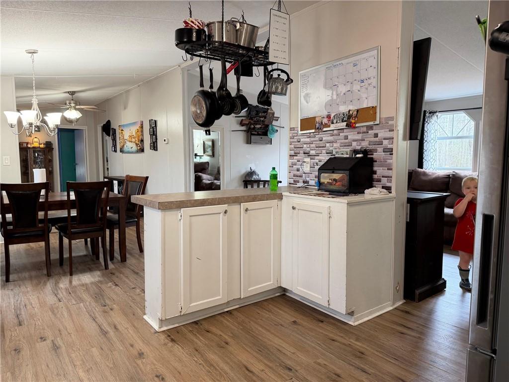 828 Harrison Road Carrollton, GA 30117 - Photo 19 of 20 a kitchen with stainless steel appliances kitchen island wooden floors and wooden cabinets