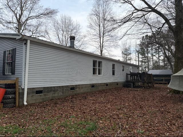 828 Harrison Road Carrollton, GA 30117 - Photo 20 of 20 a backyard of a house with wooden fence and large trees