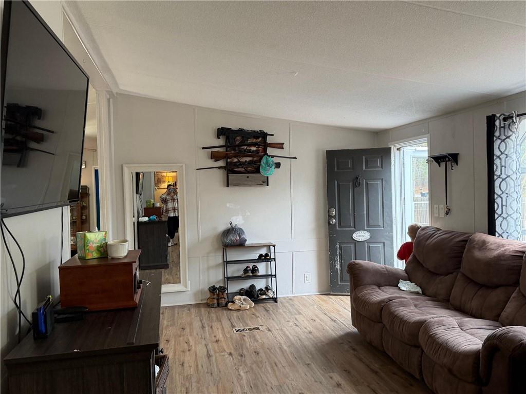 828 Harrison Road Carrollton, GA 30117 - Photo 4 of 20 a living room with furniture and a flat screen tv