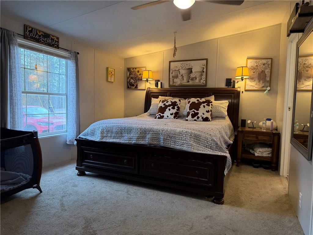 828 Harrison Road Carrollton, GA 30117 - Photo 7 of 20 a bedroom with a bed dresser and a window