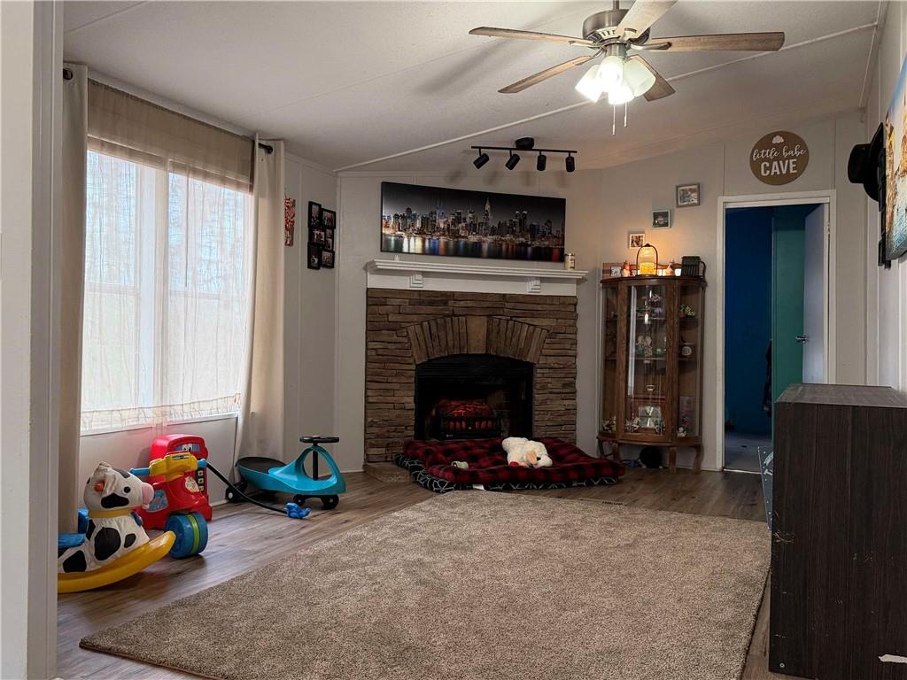 828 Harrison Road Carrollton, GA 30117 - Photo 8 of 20 a living room with furniture and a fireplace