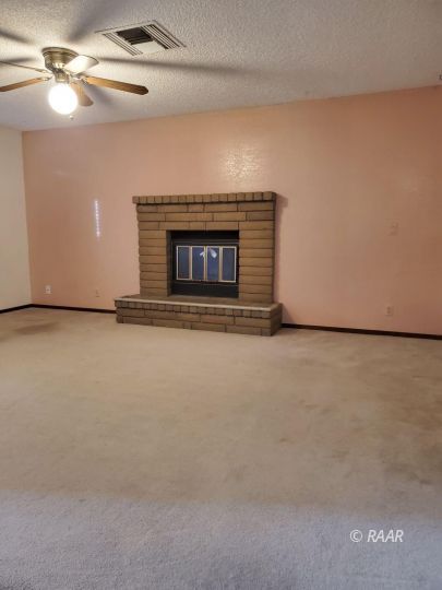 342 East Wilson Avenue Ridgecrest, CA 93555 - Photo 6 of 27 a view of an empty room with a fireplace