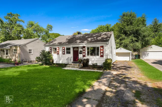 a view of a house with a yard and sitting area