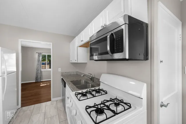 a kitchen with stainless steel appliances a stove a microwave and cabinets