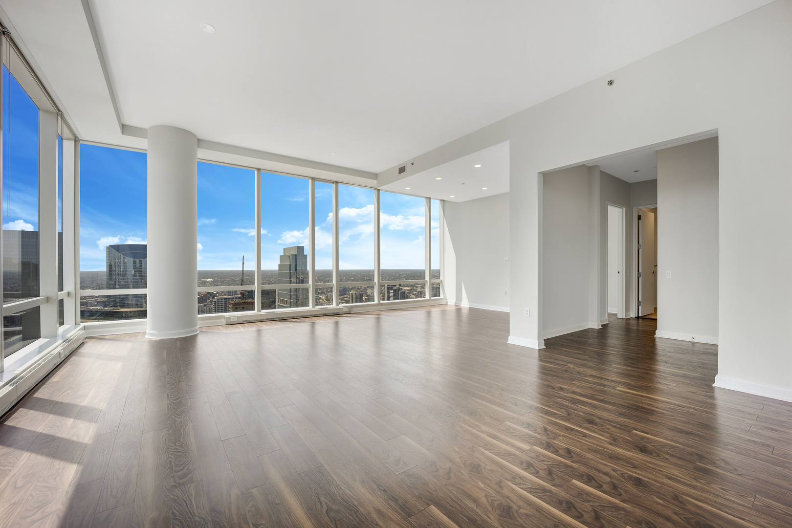 111 West Wacker Drive, Unit PH01 Chicago, IL 60601 - Photo 2 of 37 a view of an empty room with wooden floor and a window