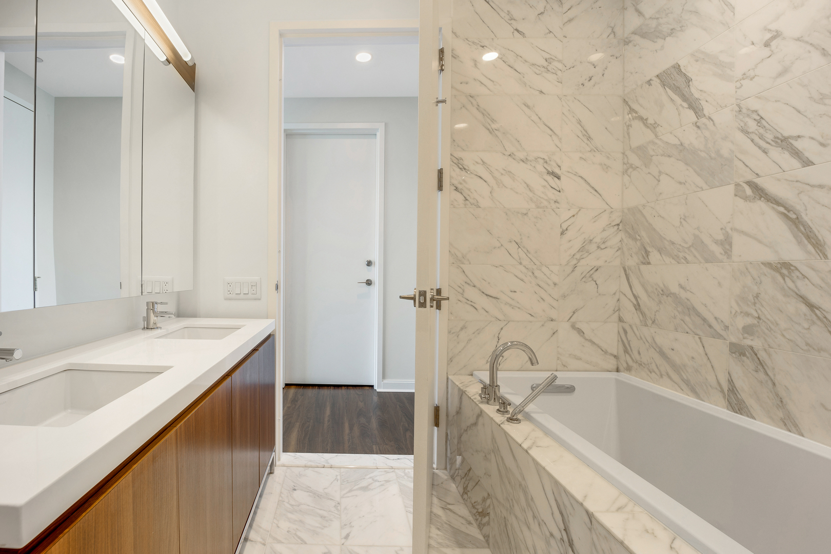 111 West Wacker Drive, Unit PH01 Chicago, IL 60601 - Photo 16 of 37 a bathroom with a tub sink and mirror