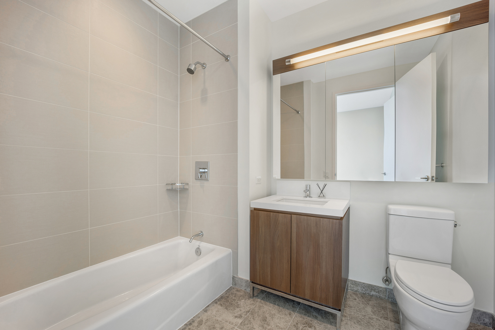 111 West Wacker Drive, Unit PH01 Chicago, IL 60601 - Photo 18 of 37 a bathroom with a sink a toilet and shower
