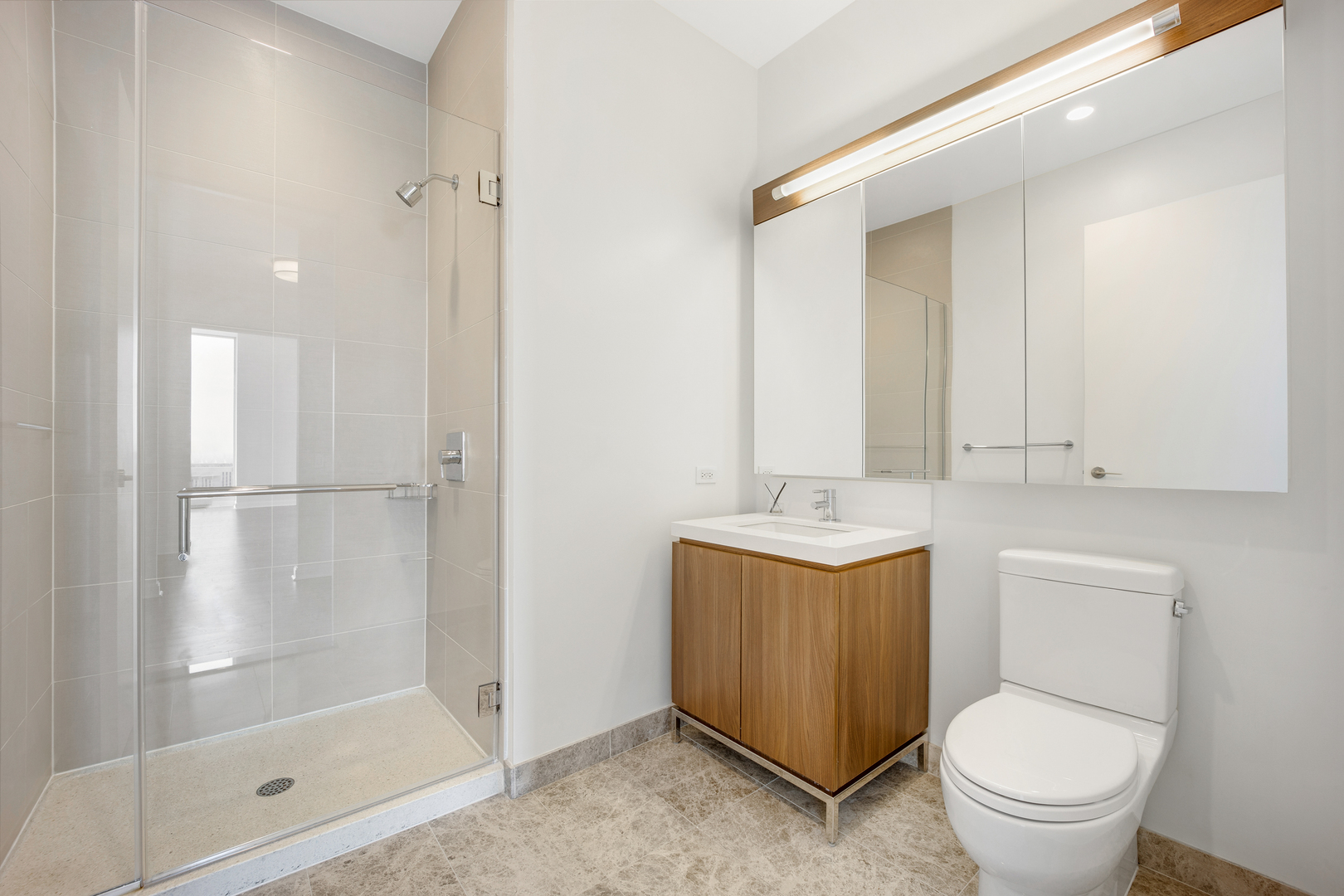 111 West Wacker Drive, Unit PH01 Chicago, IL 60601 - Photo 19 of 37 a bathroom with a sink a toilet and shower